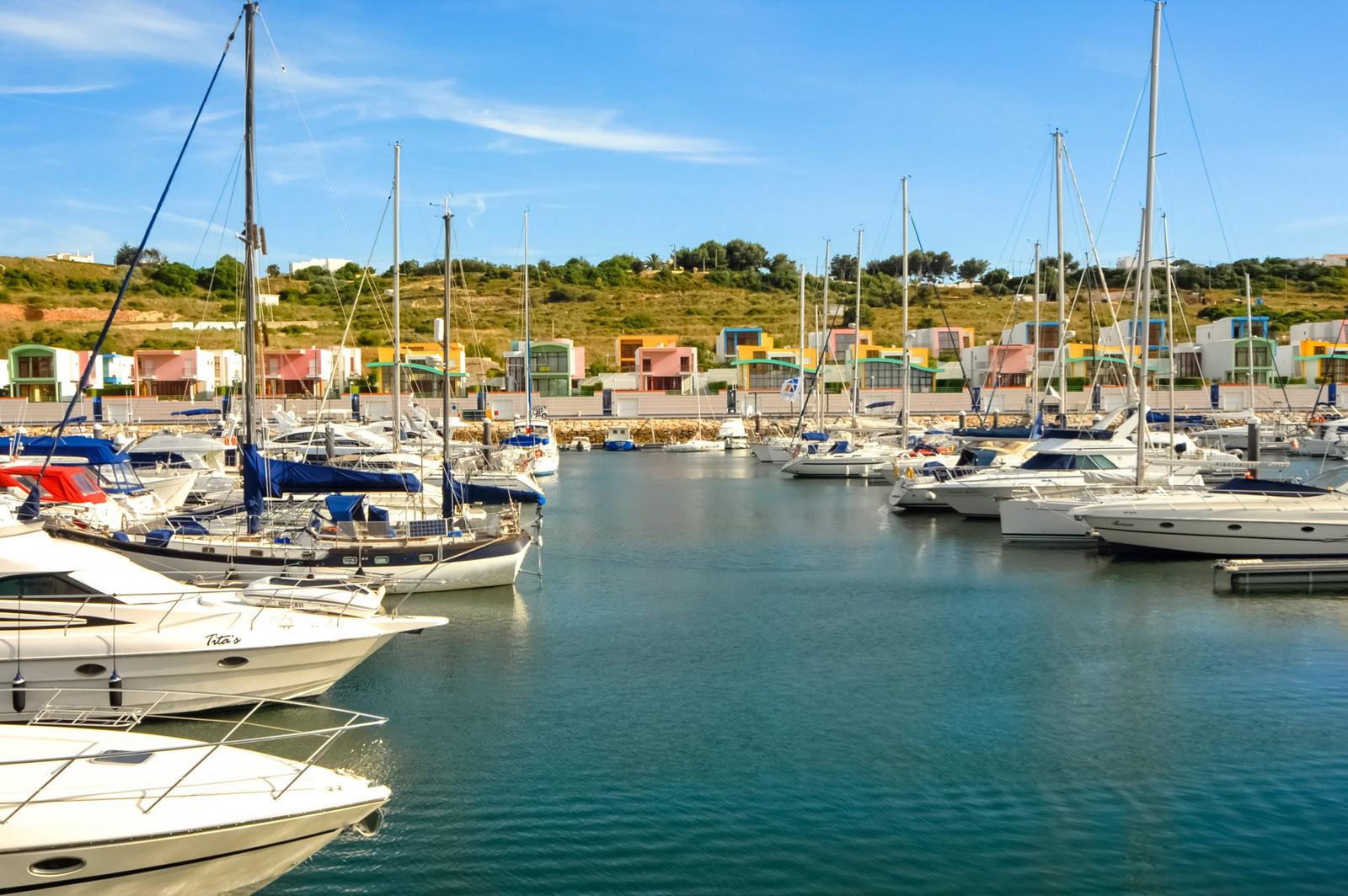 Barcos na Marina de Albufeira com casas coloridas ao fundo