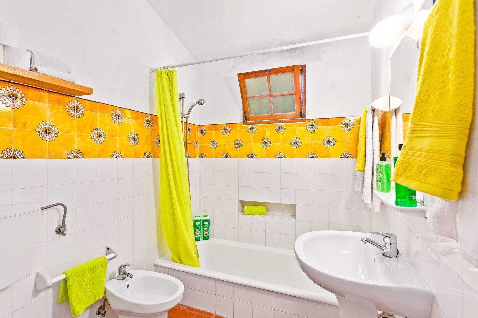 Casa de banho com azulejos amarelos